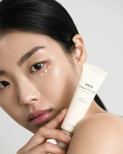 Woman holding a skincare product labeled 'Abib' against a neutral background