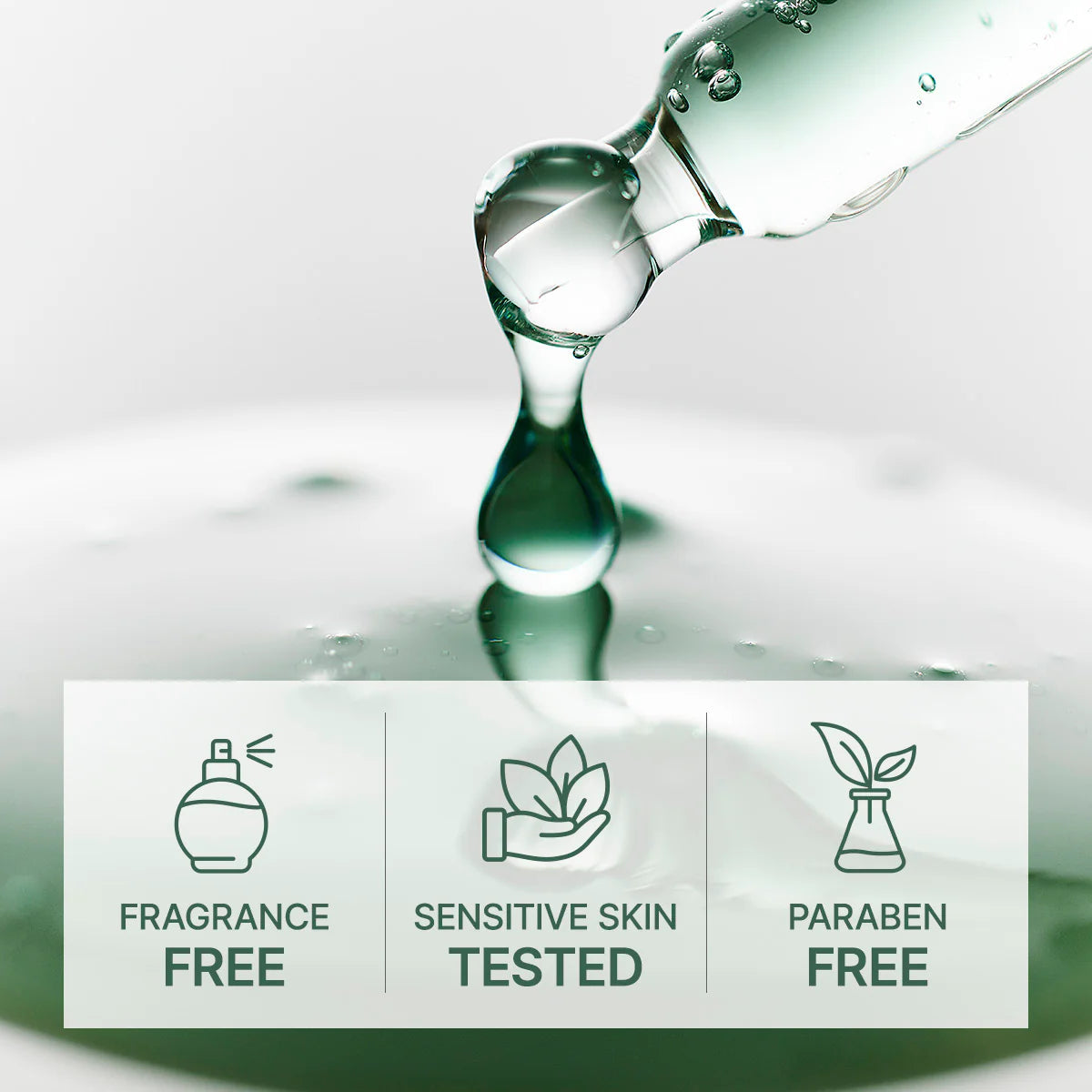 Bottle pouring liquid with icons and text indicating fragrance-free, sensitive skin tested, and paraben-free on a reflective surface.