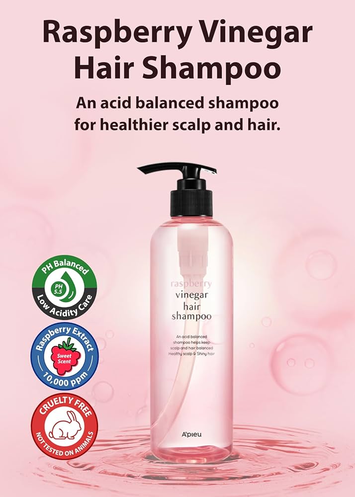 Raspberry vinegar hair shampoo bottle with product features on a pink background