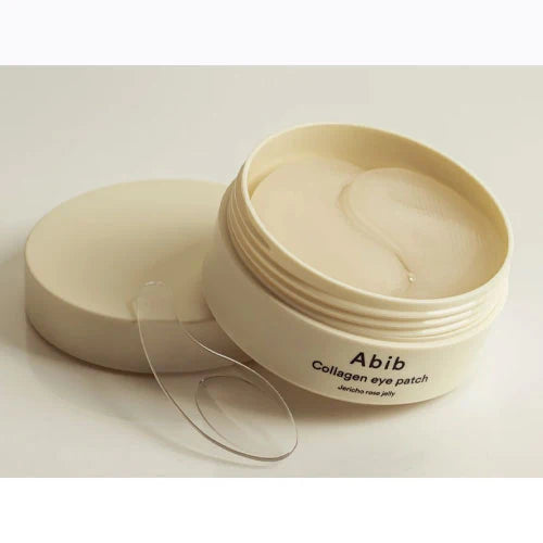 Collagen eye patch container with lid open on a white background