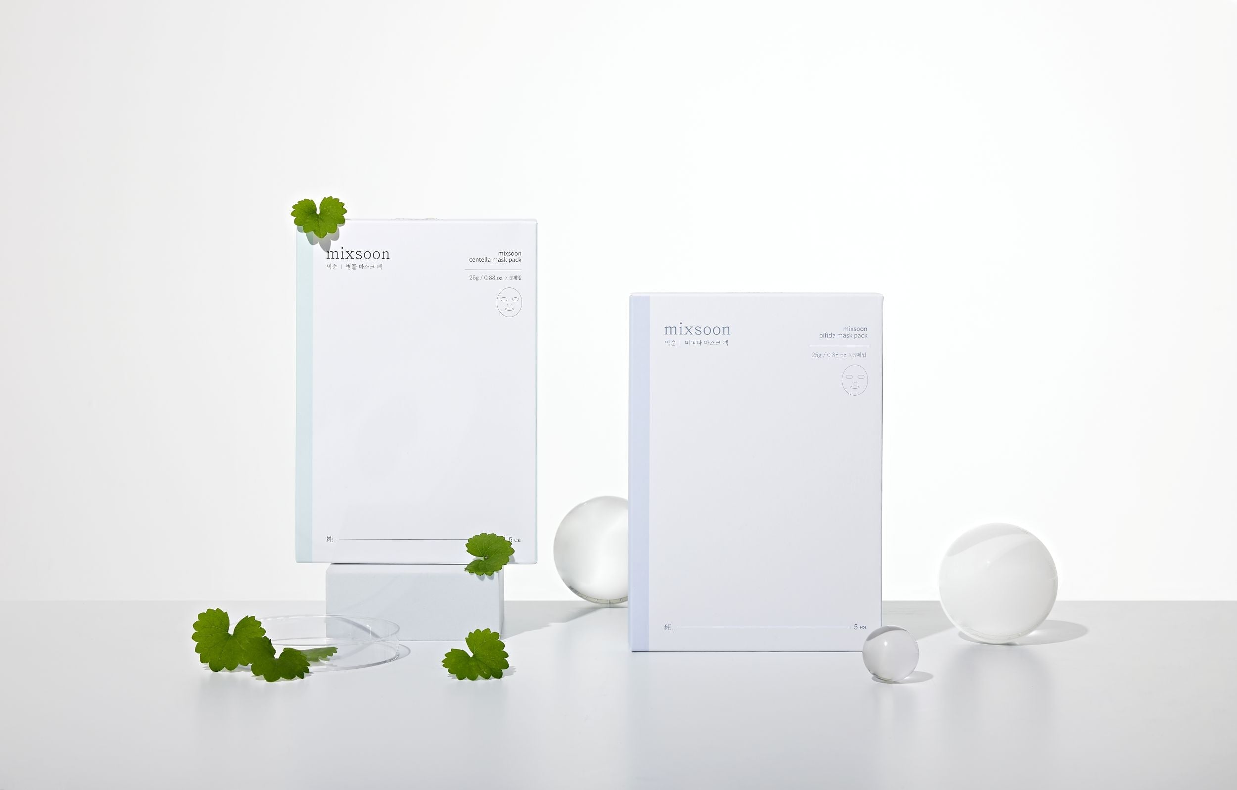 Two white package containers of mixsoon bifida masks with green leaves on a white background 