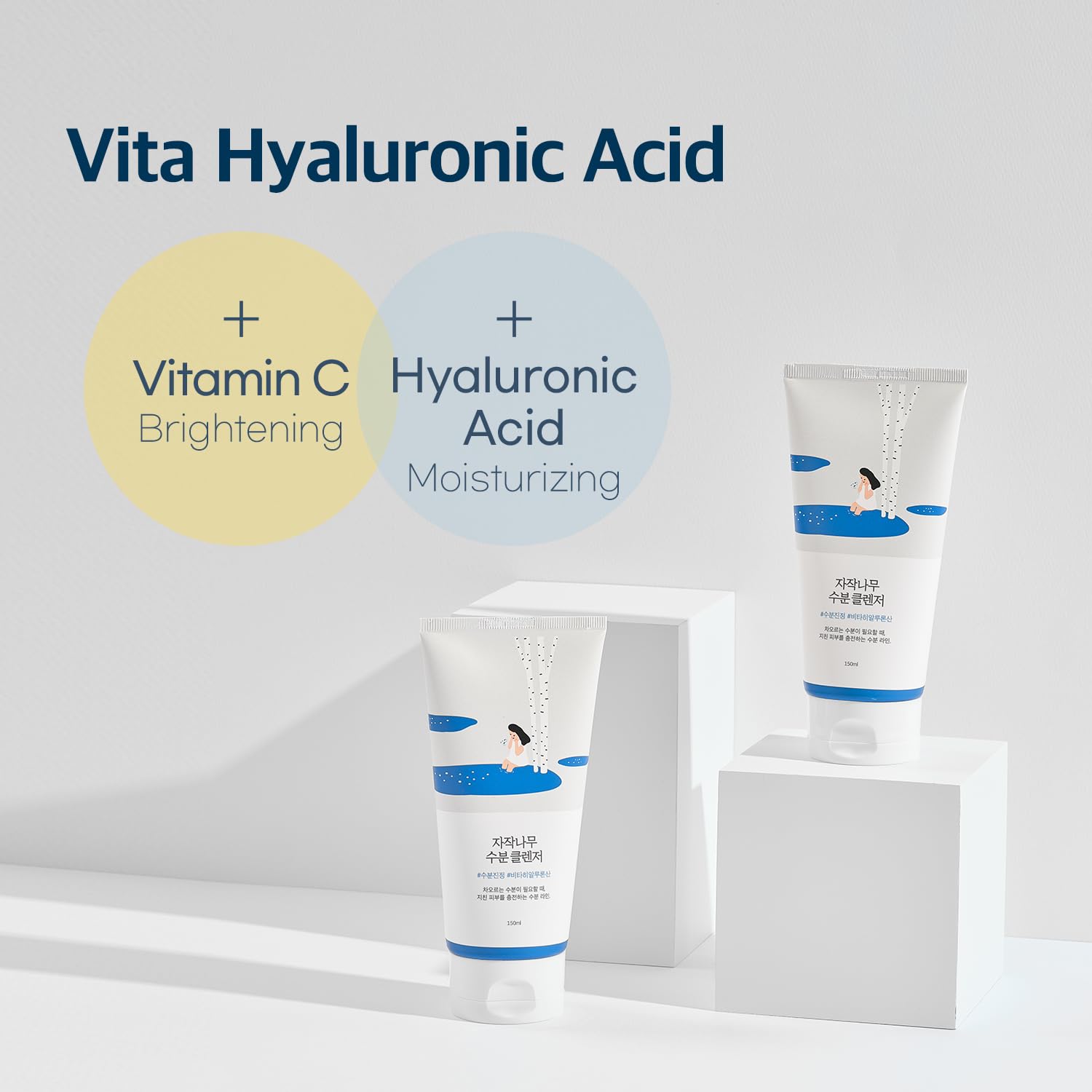 Two round lab birch juice skincare products with text highlighting Vita Hyaluronic Acid, Vitamin C, and Hyaluronic Acid on a light gray background.