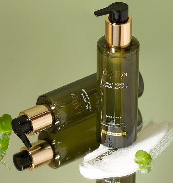 d'Alba Mild Skin Balacing Vegan Cleanser 200ml Two skincare bottles with gold caps and black nozzles on a green background