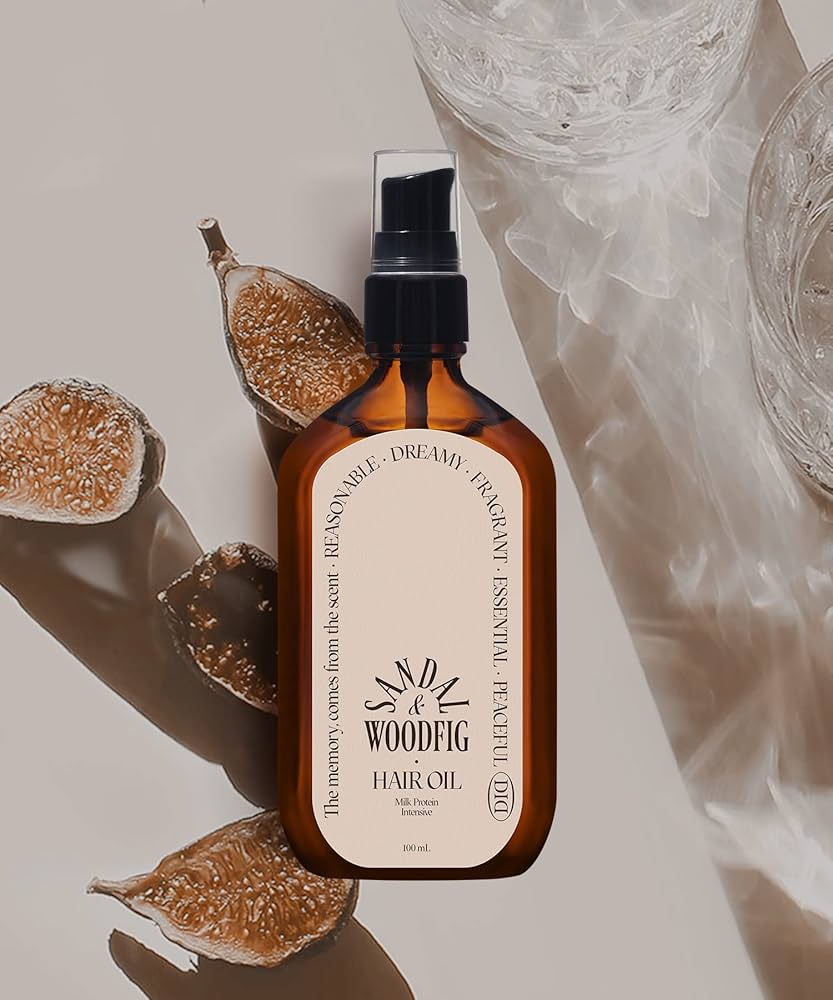 Brown bottle of Woodieg hair oil with dried figs on a neutral background